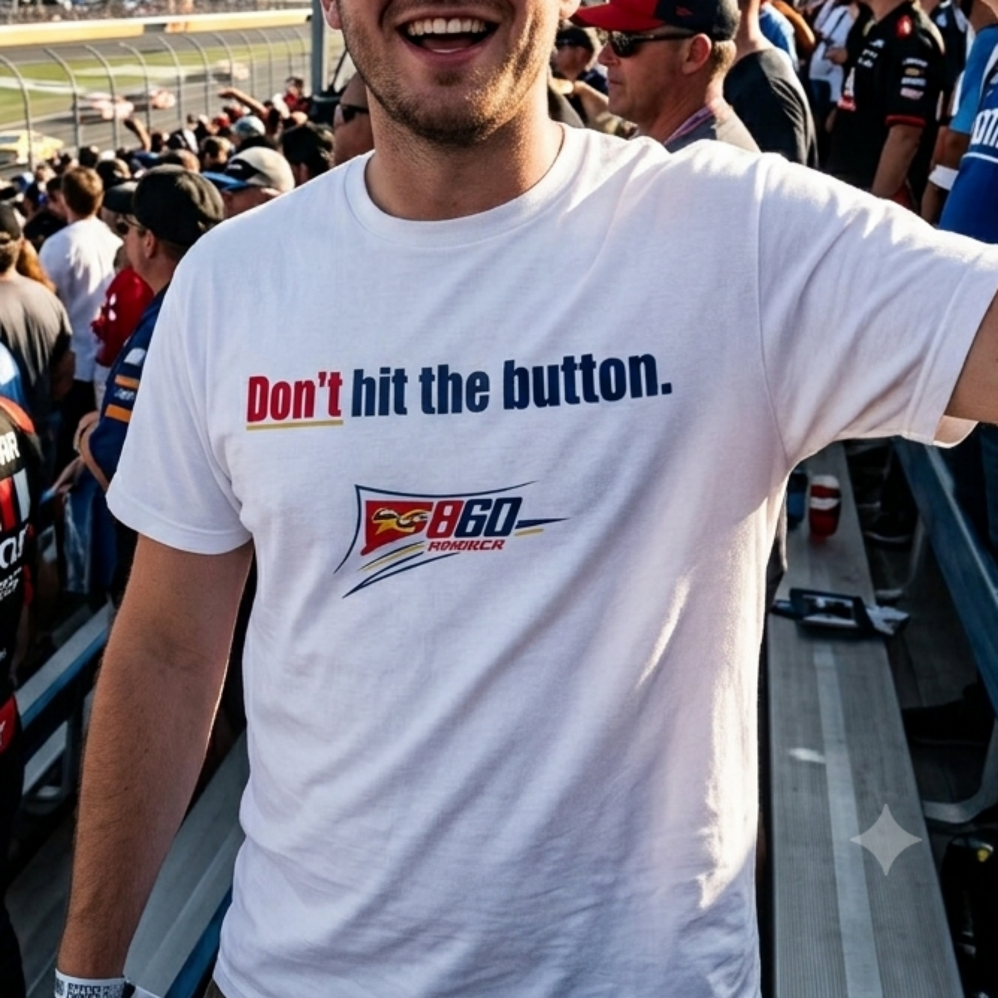 A man smiling in a race track grandstand wearing a white t-shirt with the text 'Don't hit the button.' and a Pispex 860 logo, holding up a drink.